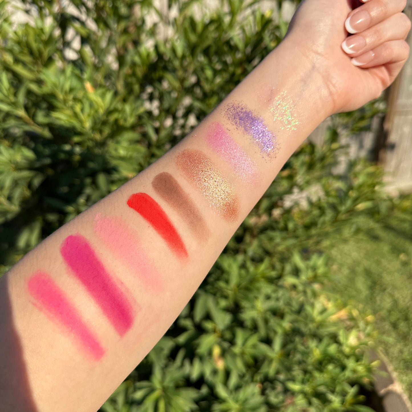 Eyeshadow swatches of the shortcake palette on the arm in natural  lighting from Fresa Cosmetics